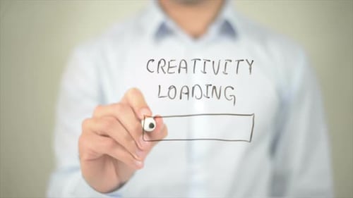 Creativity Loading Man Writing on Transparent Screen