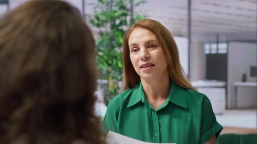 HR Recruiter Examines a Candidate Resume During a Formal Job Interview