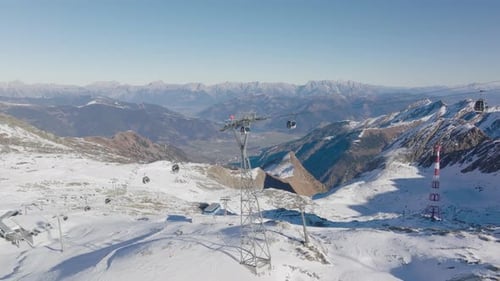 Drone Towards Ski Lift Over Ski Slope On Mountain