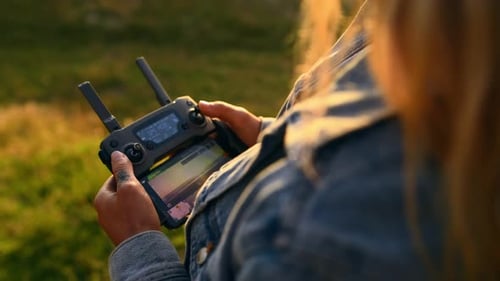 Drone, photography and woman with remote in hands at park in summer with futuristic