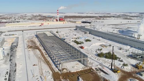 Grey Carcass of Future Workshop at Snowy Construction Site
