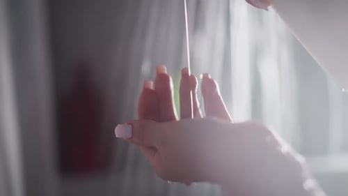 Woman Flows Soap on Hand in Shower and Rubs in Hand