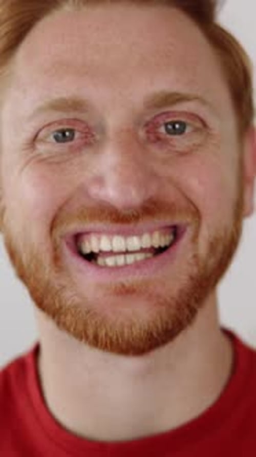 Portrait of Young Red Haired Man Smiling at Camera