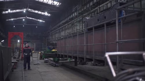Industrial Engineer Supervising Machinery in Large Factory