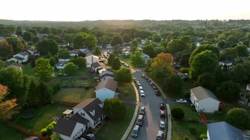 Cars parked along street in residential neighborhood in USA. Summer aerial of residential houses and