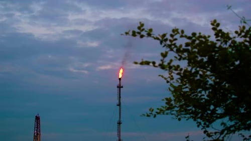 Tall chimney flares gas resulting in emissions and climate change