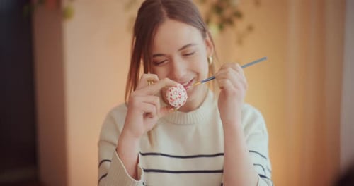 Portrait of Woman Painting Easter Eggs for Easter Holidays