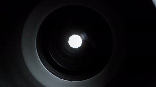 Diaphragm aperture smoothly widens, macro view inside the optical device.