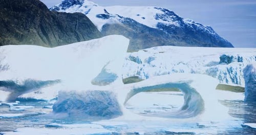 Majestic Ice Formations and Snow Capped Mountains in a Serene Landscape