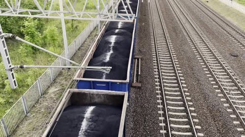 Cargo Train in Motion Loaded with Black Coal Top View From Above Railway Cargo Cars Freight Train