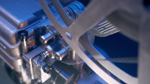 Closeup of Spinning Film Projector Reel in Vintage Movie Theater Adds Nostalgic Touch to Working