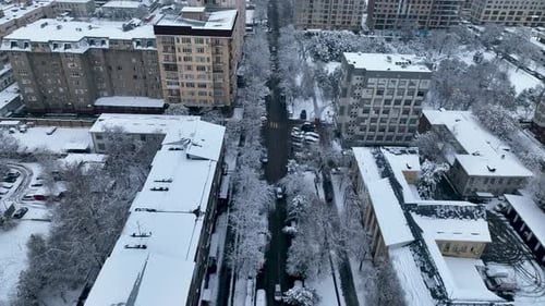 Aerial view of snow covered Soviet era apartment blocks and city street