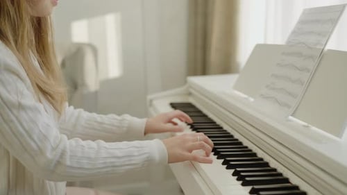 Hands Pressing the Piano Keys Reading Sheet Music Piano Learning Lessons