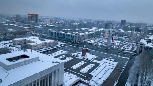 Central Bishkek covered in snow with landmarks and illuminated buildings