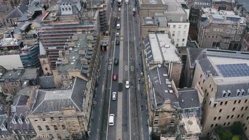 Drone flyover the road and historic buildings in city centre. Edinburgh, Scotland