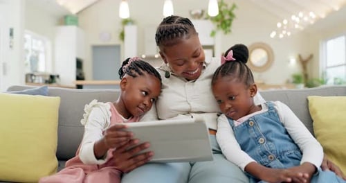Happy, mother with her girl child and tablet on sofa in living room of their home together