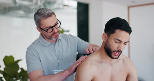 Ball, wellness or man in physiotherapy to relax body or shoulders for chiropractic healing on back