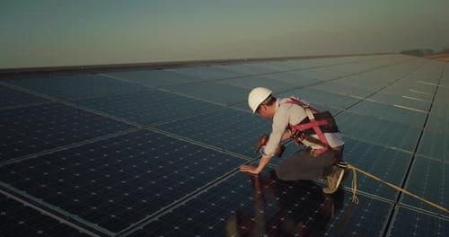 Cinematic shot of assistance technical worker in uniform checking operation and efficiency of phot