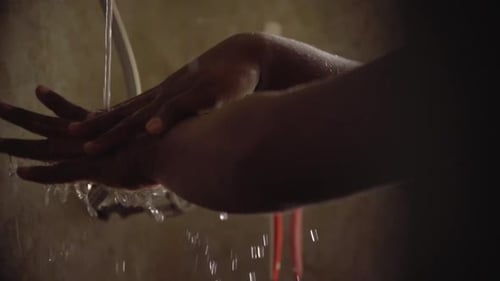 washing had in slow motion water dripping from elbow