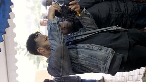 The Film Director and Camera Assistant Getting Ready for a Video Shoot - Vertical Shot