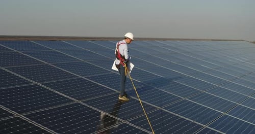 Cinematic shot of assistance technical worker in uniform checking operation and efficiency of phot