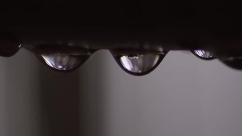 Extreme Closeup - Water Dripping & Leaking from Metal Plumbing Pipe