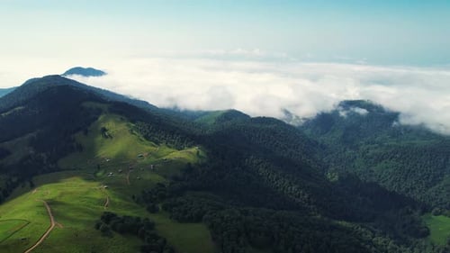 Green mountains panorama view. Clouds and mountains aerial view.