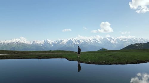 Aerial of Hiker with Backpack Walking By Koruldi Lakes in Svaneti Mountains Adventurous Trekker