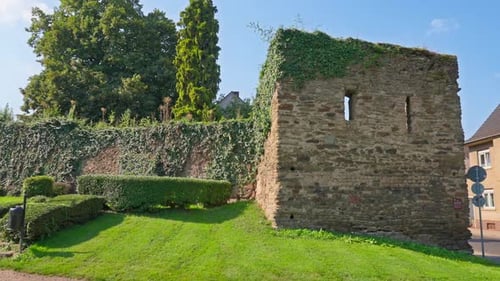 Remains of a Medieval European stone wall enterance on a sunny summer day with parallax tracking