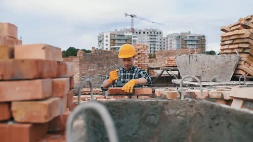 Construction worker in uniform and safety equipment have job on building