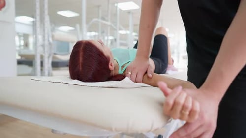 Professional Doctor Physiotherapist Working Injury Recovery with Female Athlete