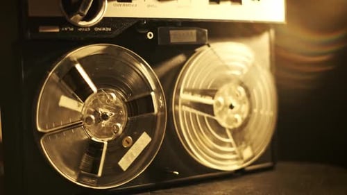 Finger Presses Play on Reel Tape Audio Player Machine