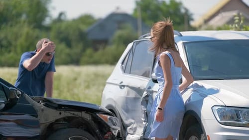 Drivers of Smashed Vehicles Arguing Who is Guilty in Car Crash Accident on Street Side