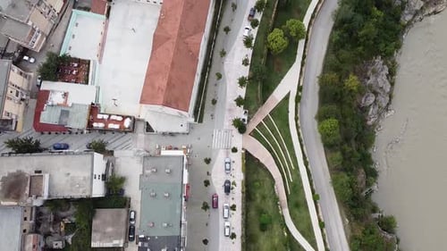 Aerial view of red vehicle driving through residential area