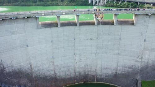 Aerial drone view of bungee jumping dam platform 50m high , viewers standing on dam bridge watching