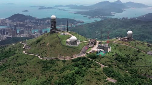 Aerial view of Sun rising at the tallest mountain Tai Mo Shan in Hong Kong with colorful blue sea an