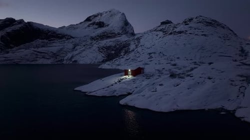 Winter Serenity at Lofoten Islands Captured in an Image of a Softly Lit Scandinavian Fishing Home on