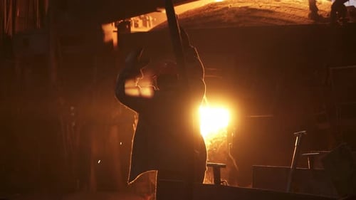 A Dedicated Workers Silhouette Shines in an Industrial Setting Highlighting Their Key Role Stock