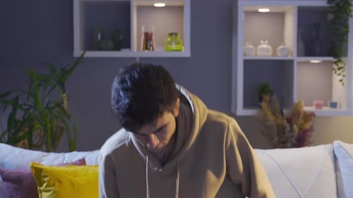 A worried young man covering his face with a feeling of regret.