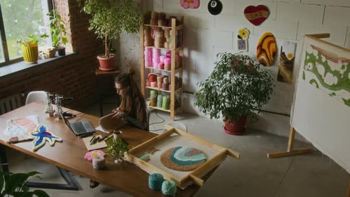 Rug Tufting Studio with Creative Woman using Computer