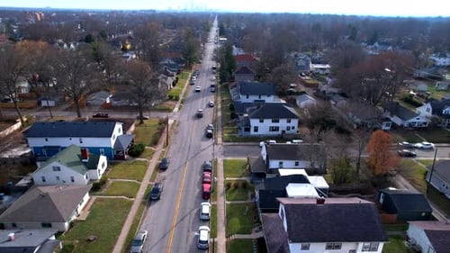 Car Driving On The Street In A Suburban Neighborhood On A Sunny Day In Autumn. aerial following