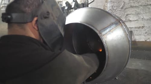 Worker in Protective Mask Welding Metal Construction at Industrial Production Welder Welds Metal