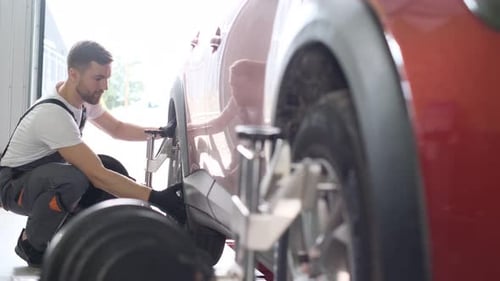 The Mechanic Checks the Chassis for Any Damage or Wear