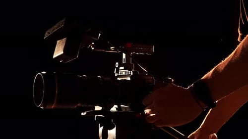 Silhouette of Person Operating Professional Video Camera