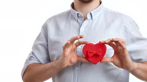 Male Hands Hold Small Red Gift Box with Bow Valentine's Day Festive Present Posing Isolated