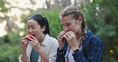 Friends, eating and relax on hike outdoors, conversation and healthy meal for break on trek