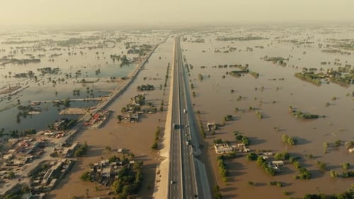 aerial - highway cutting through vast floodplain in Jalalpur Pirwala Punjab Pakistan 2025