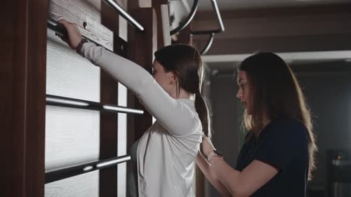 Medical Sports Rehabilitation After Injury and Surgery A Medical Trainer Works with a Patient Under