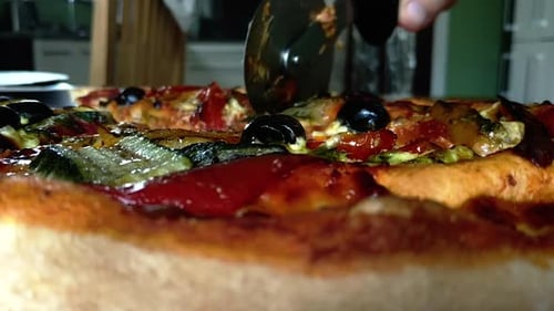 Vegetarian Pizza with olives and peppers, hand cuts slice, static