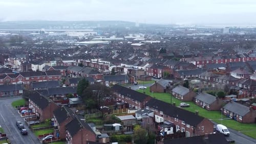 Aerial view above North England terraced residential town neighbourhood property zoomed in